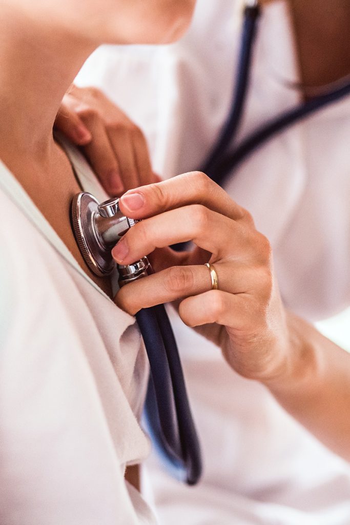 Lowcountry urgent Care doctor checking patient with stethoscope